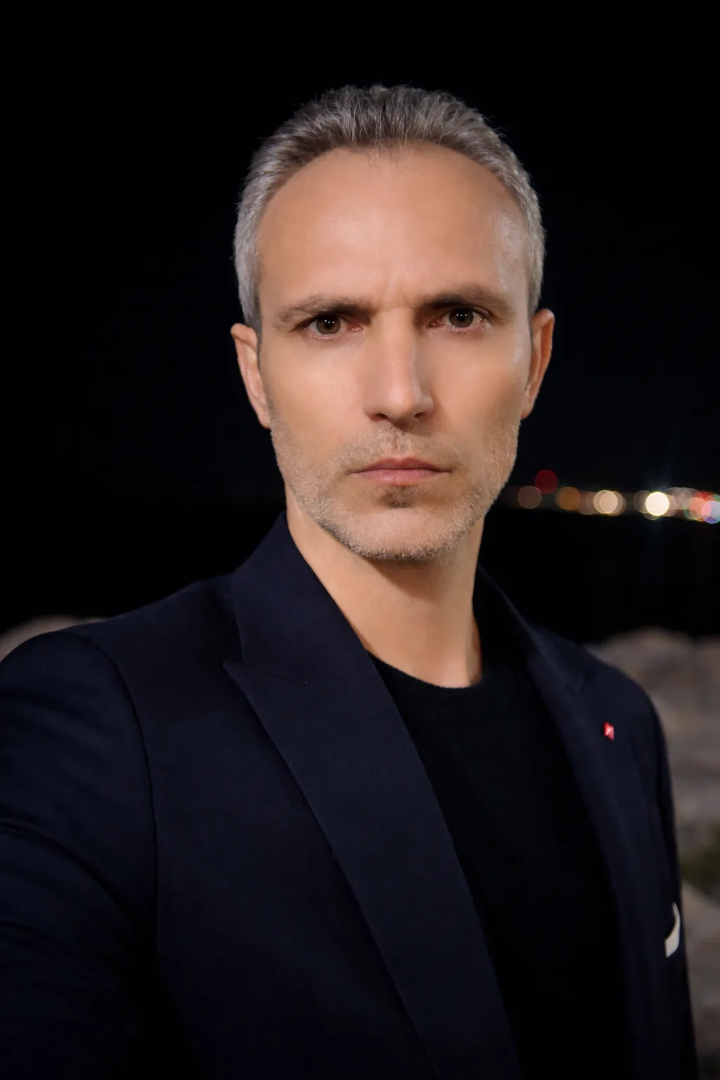 Galip Arduç kişisel marka sitesinde kullanılan, gece atmosferinde koyu lacivert ceketli ciddi ve profesyonel erkek portresi.